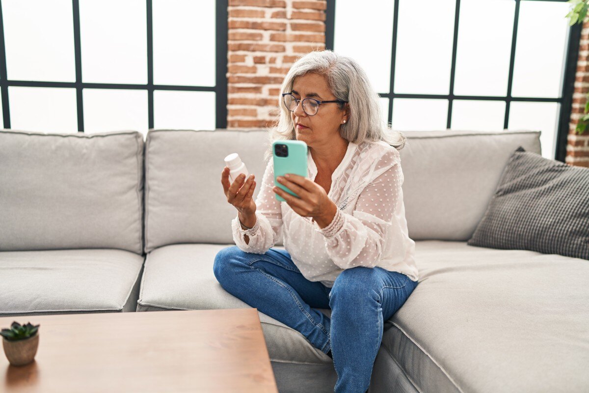 Older woman talks to remote pharmacist via video chat 513312235