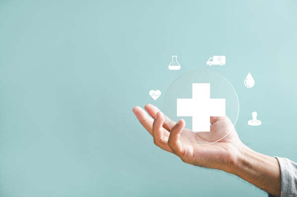 hand holding healthcare symbol with various surrounding icons_668396638