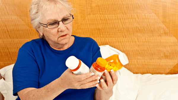 patient holding medication confused