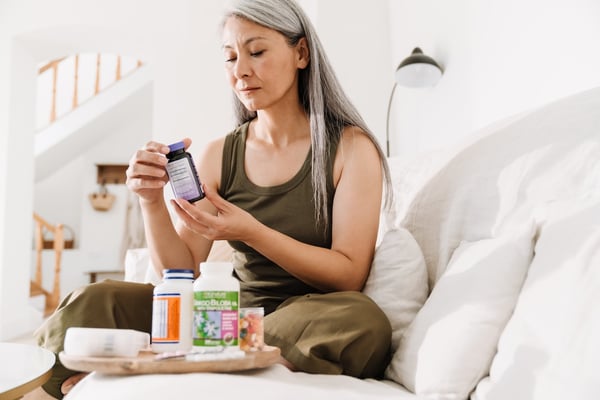 patient at home reviewing multiple medications