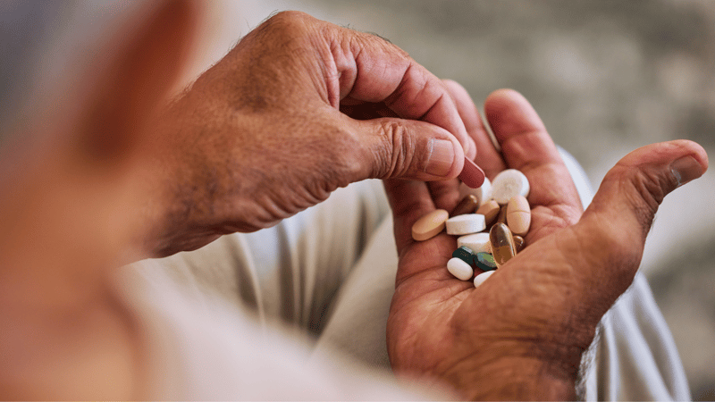patient holding medication for chronic disease management