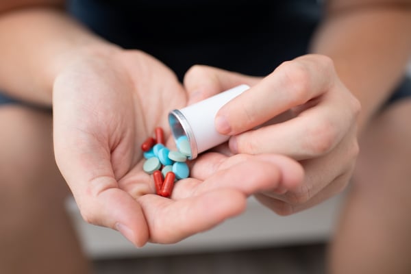 patient holding medications in their hand
