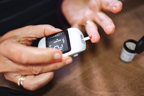 patient measuring glucose levels for chronic condition management using a handheld device