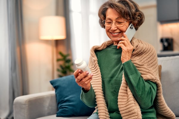 patient speaking on the phone with a pharmacist about statin therapy