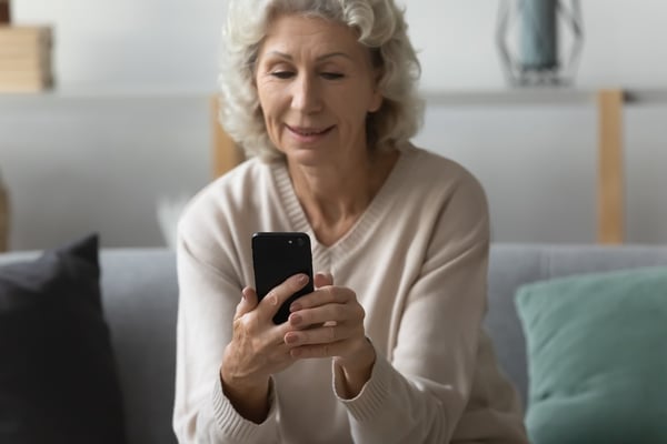 patient using cell phone for telepharmacy services