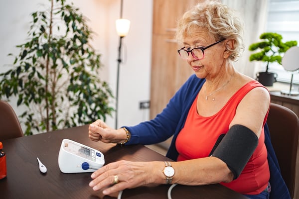 patient using technology to measure blood pressure