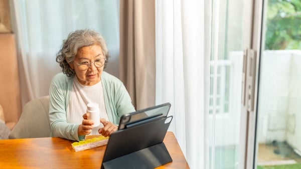 senior woman using pharamcy software to connect with a remote pharamcist for healthcare services at home