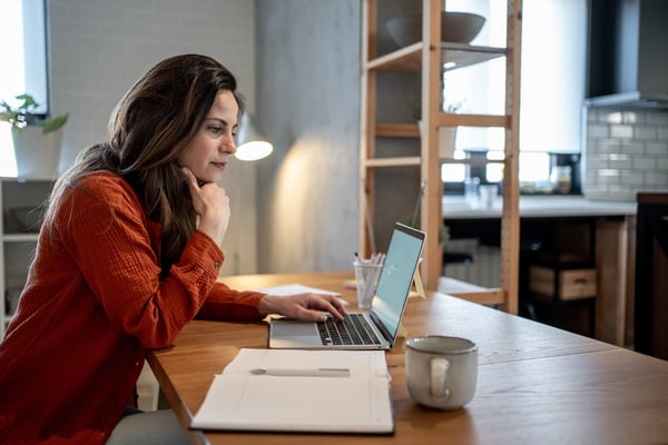 transitions of care pharmacist reviewing laptop for patient assistance